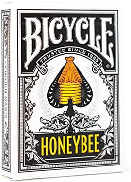 Bicycle Honeybee playing cards featuring a creative design with a yellow honeycomb structure and intricate floral patterns, emphasizing quality and craftsmanship. The packaging showcases the trusted Bicycle brand, known for its classic and innovative games since 1885.