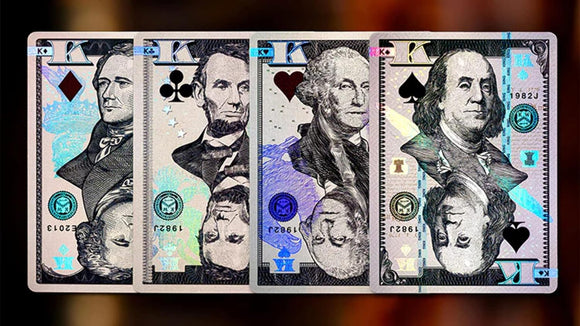 A set of Legal Tender Luxury Playing Cards by Kings Wild displayed face up. Each card features iconic American figures depicted in a dollar bill style design, showcasing vibrant colors and intricate details.