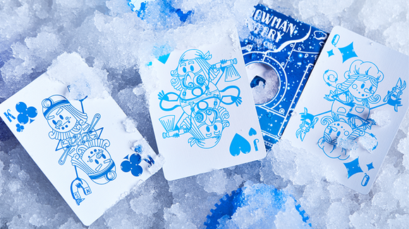 A set of Snowman Factory Playing Cards displayed on a bed of ice, featuring whimsical illustrations of snowmen engaged in various winter activities, with vibrant blue designs and playful motifs. The cards are creatively designed for festive fun and winter-themed games.