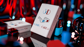 A stylish pack of 3D Playing Cards by Nacho Montenegro, positioned prominently against a vibrant background with red and blue reflections. The packaging features eye-catching graphics and the words '3D PLAYING CARDS', inviting a visually immersive gaming experience.