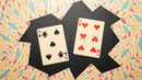 Ace Invaders Playing Cards featuring playful card designs with unique graphics. The set includes illustration of a black spade card (5) and a red heart card (6) amidst colorful patterned backgrounds.