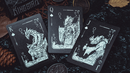 A close-up view of three detailed playing cards from the 'Words of Dragon' deck by King Star. The King card features a dragon design, while the Queen and Jack cards depict armored figures associated with dragons. Each card has intricate artwork with vibrant colors set against a textured black background, ideal for card games and collectors.