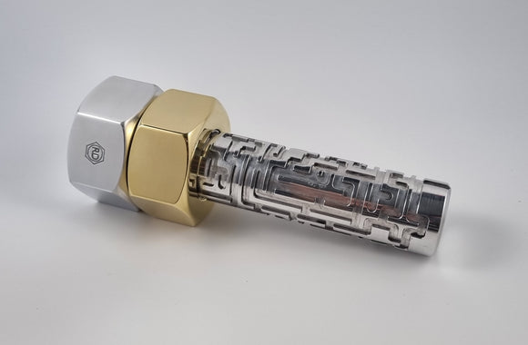 Maze Bolt by Roger D. is a mechanical puzzle featuring an intricate design. The puzzle consists of a shiny metallic rod encased in two differently colored hexagonal nuts, offering a captivating and challenging experience for puzzle enthusiasts. Its elegant construction combines functionality with aesthetic appeal, making it an ideal gift for anyone who loves brain-teasers.