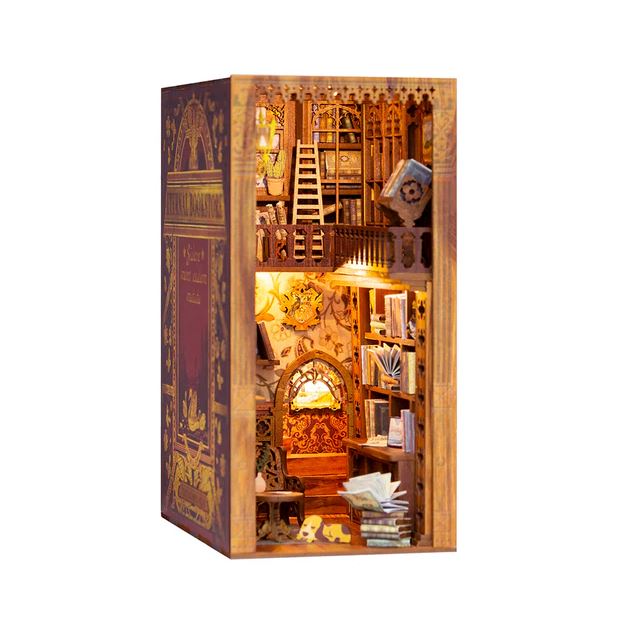 A beautifully crafted DIY miniature kit entitled 'Eternal Bookstore with Dust Cove' by Cute Bee. The scene features a detailed interior of a bookstore, complete with shelves filled with books, a wooden ladder, and decorative elements, all illuminated softly to create a warm ambiance. The exterior is adorned with ornate designs, resembling a classic book.