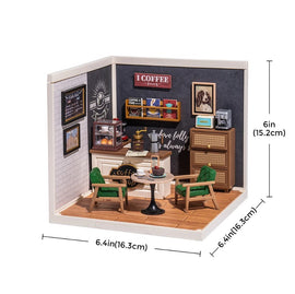 A detailed miniature DIY kit representing a cozy cafe scene. It features a small coffee shop interior with a counter, coffee-making equipment, green chairs, a table, and decorative wall art. Dimensions are 6.4 inches wide and 6 inches tall, showcasing a charming and creative design for cafe lovers.