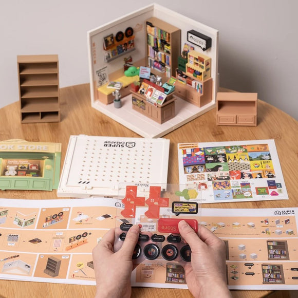 The Fascinating Book Store DIY kit by Robotime showcases a detailed mini bookstore model. The image displays a partially assembled bookstore with bookshelves, a checkout counter, and a variety of books and decorations. There are also assembly instructions and components on the table, including a control panel, emphasizing the engaging and creative nature of this DIY project.