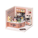 The Double Joy Bubble Tea DIY kit by Robotime features a detailed miniature bubble tea shop setup. It showcases a vibrant, playful design with a counter displaying various bubble tea items, a blender, cups, and colorful signage. This creative and engaging DIY project allows users to build their own bubble tea shop, complete with all the accessories reminiscent of a real shop.