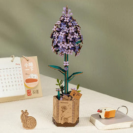 The Lilac Model by Robotime is a beautifully crafted DIY kit featuring a lilac flower design. The model showcases intricate details of the petals and leaves, standing tall in a pot adorned with small decorations. It offers a unique crafting experience, perfect for home decor enthusiasts and DIY lovers alike.