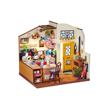 A detailed and charming miniature DIY house kit depicting a cozy kitchen scene. Features include a wooden table with food items, colorful pots, a sink, and a welcoming yellow door. The walls are adorned with decorative items, creating a homely atmosphere. Perfect for hobbyists who enjoy crafting and miniature building.