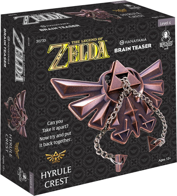 The Legend of Zelda Hyrule Crest mechanical puzzle by Hanayama features intricate designs and a bronze finish. The packaging includes the iconic Hyrule symbol and notes about the challenge level and age recommendation, inviting users to take it apart and reassemble it.