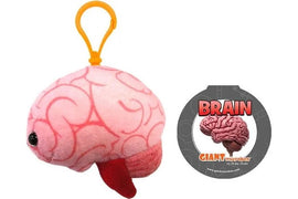A cute plush keychain shaped like a brain, featuring pink fabric with detailed brain patterns, attached to a yellow plastic clip. Accompanied by a circular tag labeled 'BRAIN' by Giantmicrobes.