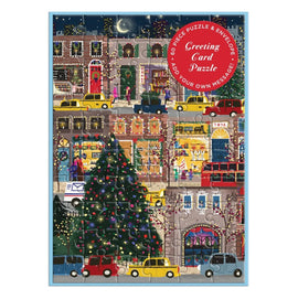 The Joy Laforme Winter Lights Greeting Card Puzzle by Galison features a charming holiday scene with a decorated Christmas tree, festive storefronts, and people enjoying the winter atmosphere. The 60-piece jigsaw puzzle can be assembled to create a colorful and interactive greeting card, perfect for personal messages during the holiday season.