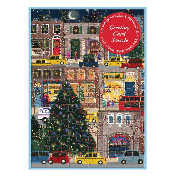 The Joy Laforme Winter Lights Greeting Card Puzzle by Galison features a charming holiday scene with a decorated Christmas tree, festive storefronts, and people enjoying the winter atmosphere. The 60-piece jigsaw puzzle can be assembled to create a colorful and interactive greeting card, perfect for personal messages during the holiday season.