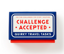 Challenge Accepted Travel Task game box featuring a vibrant blue design with bold red and white lettering. The box promises 100 fun challenges for every vacation, making it a perfect companion for adventurers and travelers looking to add excitement to their journeys.