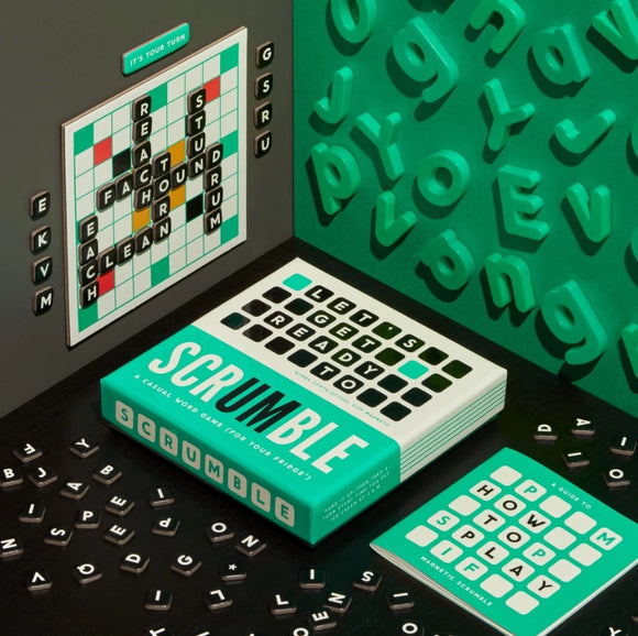 The Scrumble Magnetic Game Set by Brass Monkey features a colorful box with bold typography. The game includes a magnetic board displaying word tiles, surrounded by playful, colorful letter tiles on a green surface. Instructions for gameplay are also visible, emphasizing the casual, interactive nature of this word game designed for friends and family.