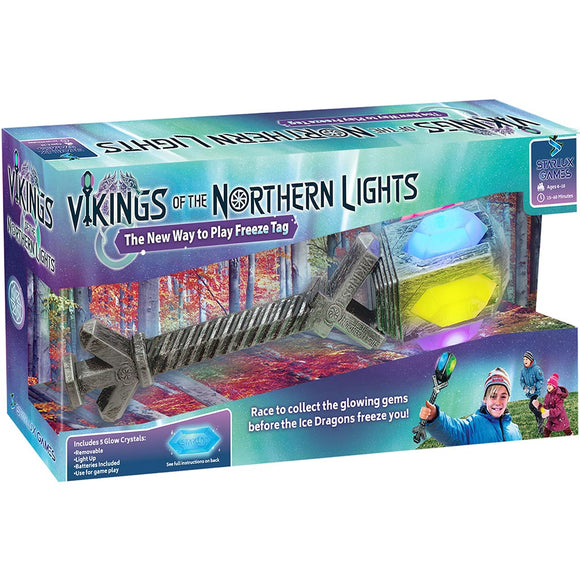 Vikings of the Northern Lights game packaging by Starlux Games. The box features a colorful illustration depicting a frozen landscape with children playing. It includes a glowing orb and a unique game tool designed like a Viking weapon, emphasizing the interactive freeze tag gameplay. The package displays 'The New Way to Play Freeze Tag' tagline, and the game is suitable for ages 6 and up, designed for 15-30 minutes of play.