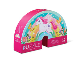 The Sweet Unicorn Mini Puzzle by Crocodile Creek features a whimsical design showcasing a colorful unicorn surrounded by butterflies and flowers. The puzzle is packaged in a vibrant pink box that is half-moon shaped, and it includes 12 pieces suitable for ages 2 and up, making it perfect for young children to enjoy.