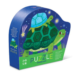 The Turtles Together Mini Puzzle by Crocodile Creek is a vibrant jigsaw puzzle featuring colorful illustrations of turtles. The packaging is shaped like a turtle, displaying a blue turtle on top of a green turtle against a whimsical starry background. Suitable for ages 2 and up, it includes 12 easy-to-handle pieces, perfect for young children to enjoy assembling.