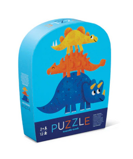 Dino Friends Mini Puzzle by Crocodile Creek, featuring colorful cartoon dinosaurs on the packaging. The puzzle box is designed for ages 2 and up and contains 12 pieces, making it perfect for young children. The vibrant illustrations showcase a playful theme with stacked dinosaurs, ideal for engaging little ones in fun, educational play.