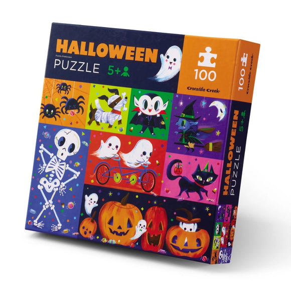 Crocodile Creek's Halloween Jigsaw Puzzle featuring colorful and whimsical illustrations of ghosts, pumpkins, skeletons, and other Halloween-themed characters. The puzzle consists of 100 pieces and is designed for ages 5 and up, making it a perfect festive activity for families. The box showcases various fun images, including playful ghosts riding bicycles and cute black cats against a vibrant Halloween backdrop.