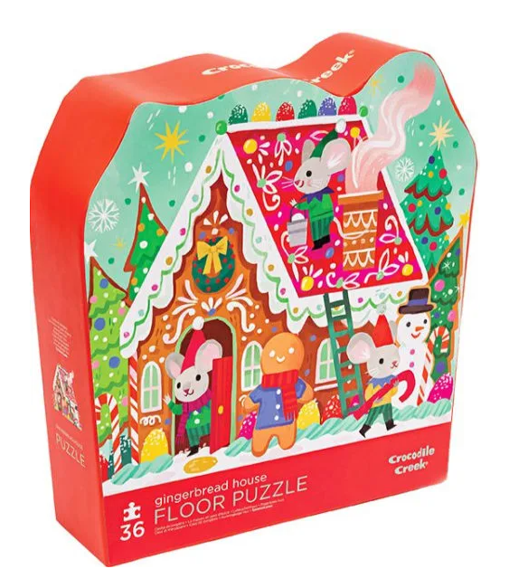 Gingerbread House jigsaw puzzle by Crocodile Creek featuring a whimsical design of mice decorating a gingerbread house surrounded by festive elements like trees, snowmen, and colorful decorations. Ideal for children, it includes 36 large pieces for easy handling and fun play.