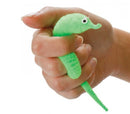 A person holding a bright green Magic Wriggler toy, shaped like a playful sea creature with googly eyes. The toy has a flexible body, designed for squeezing and relaxing, perfect for fidgeting or stress relief.
