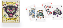 Tattoo Playing Cards by Kikkerland featuring unique designs, including a colorful panther on the box and illustrated playing cards with intricate tattoo art like a dragon, horse, and a skull.
