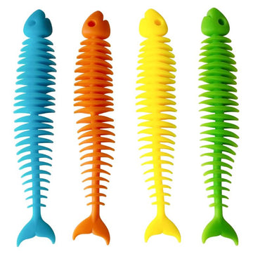 A set of four colorful squishy fish skeletons made of soft, flexible material. The fish are blue, orange, yellow, and green, each with a spiky spine design. These fidget toys are perfect for stress relief and sensory play.