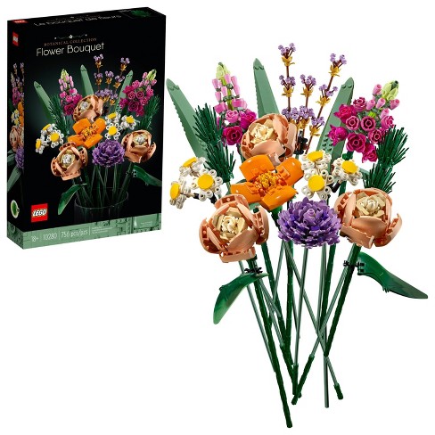 A colorful LEGO® Flower Bouquet DIY kit featuring intricately designed plastic flowers, including roses and daisies, arranged in a hand-crafted bouquet style with vibrant green leaves. The kit's packaging shows the assembled bouquet and indicates it includes 756 pieces for creative building.