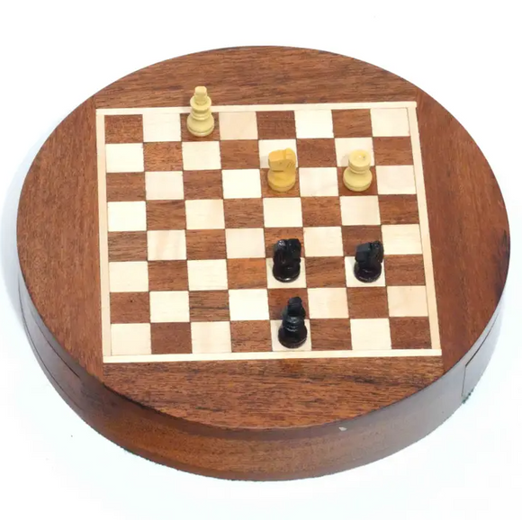A 6-inch wooden chess set displayed as a round magnet. The chessboard features a checkered design in light and dark wood, with yellow and black chess pieces positioned on it. The entire assembly has a polished finish, reflecting craftsmanship and elegance, ideal for collectors and chess enthusiasts.