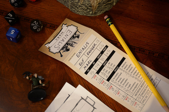 StatTrac Character Trackers 5e by TopDog Games. The image features a detailed character sheet showing stats for an Elf Ranger named Enialis. Nearby are dice, a pencil, and miniature figurines, indicating gameplay elements.