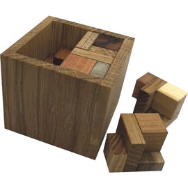 The Coverwe XS mechanical puzzle by VINCO features a wooden block design with various colored wooden pieces used to challenge the player. The puzzle is displayed in a cube shape with some pieces lying next to it, showcasing the intricate craftsmanship and complexity of the puzzle.