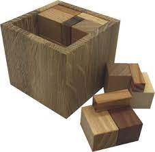 Coverdia XS by VINCO is a mechanical puzzle featuring a wooden cube with matching wooden blocks. The goal is to fit the blocks back into the cube, providing a challenging and engaging brain teaser for puzzle enthusiasts. The natural wood finish showcases fine craftsmanship.