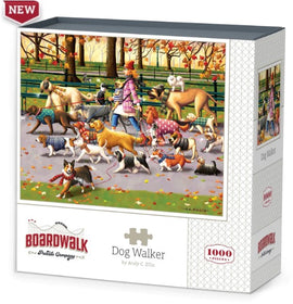 A colorful jigsaw puzzle box titled 'Dog Walker' created by Dowdle Folk Art, featuring an illustration of a person walking multiple dogs in a park during fall, showcasing various dog breeds and vibrant autumn leaves. The puzzle contains 1000 pieces and is designed by artist Andy C. Ellis.