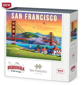 A jigsaw puzzle titled 'San Francisco' by Dowdle Folk Art, featuring the iconic Golden Gate Bridge, colorful landscapes, and serene water scenes. The box displays the vibrant artwork and indicates that it contains 500 pieces, perfect for puzzle enthusiasts.
