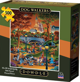 Dowdle Folk Art jigsaw puzzle titled 'Dog Walkers' featuring a colorful scene in a park with people walking dogs, surrounded by trees and buildings. The puzzle contains 500 pieces and measures 16x20 inches. The vibrant art captures a lively atmosphere with various dog breeds and joyful park-goers.