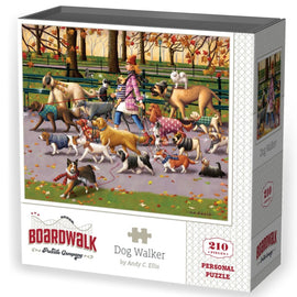 The Mini Dog Walker Boardwalk jigsaw puzzle by Dowdle Folk Art features a whimsical scene of a dog walker leading several animated dogs through a colorful park filled with autumn leaves. The puzzle box showcases vibrant artwork by Andy C. Ellis, depicting fun dog breeds in stylish sweaters, creating a delightful atmosphere for dog lovers and puzzle enthusiasts alike.