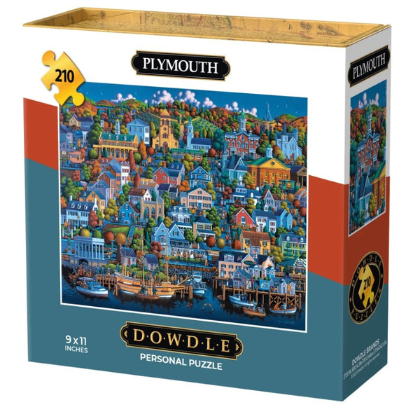 The Mini Plymouth jigsaw puzzle by Dowdle Folk Art features a colorful, detailed illustration of a quaint waterfront town with various houses, trees, and boats, presented in a sturdy box. The puzzle consists of 210 pieces and measures 9 x 11 inches, perfect for enjoyable family activities or relaxing solo time.