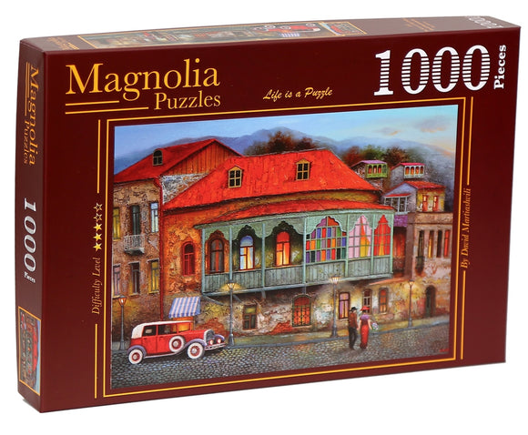 A jigsaw puzzle box featuring 'The Street of Old Tbilisi' by Magnolia Puzzles. The artwork showcases vibrant Georgian architecture with colorful rooftops and a vintage car on a cobblestone street. The puzzle contains 1000 pieces and includes a difficulty level rating of 4 stars.