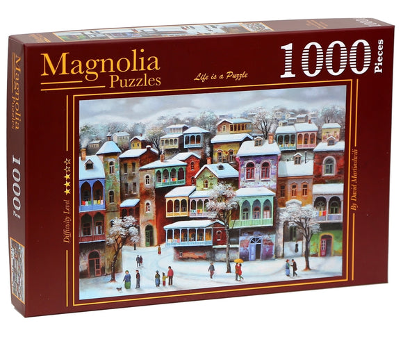 A beautifully illustrated jigsaw puzzle box titled 'Snow in Old Tbilisi' by Magnolia Puzzles. The image features a vibrant winter scene of colorful houses in Tbilisi, covered in snow, with people walking through the quaint streets. The puzzle contains 1000 pieces and has a difficulty rating of four stars, ideal for puzzle enthusiasts.