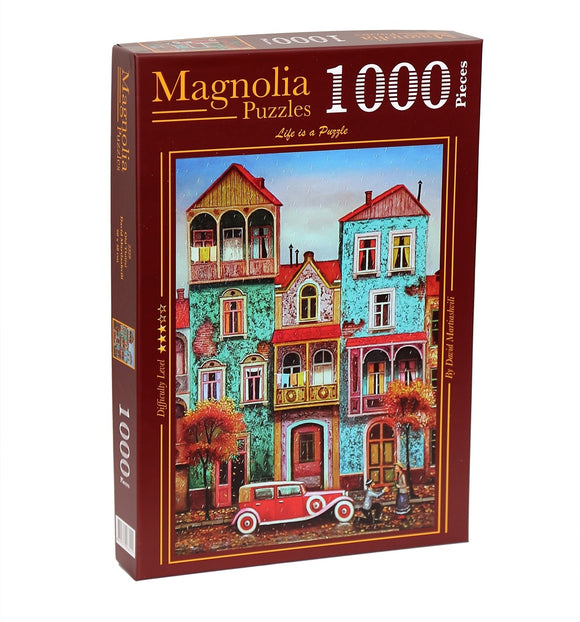 Magnolia Puzzles presents the OLD TBILISI jigsaw puzzle, featuring a vibrant, artistic depiction of historic buildings in Tbilisi, Georgia, complete with colorful facades, lush trees, and classic cars. The puzzle contains 1000 pieces, suitable for puzzle enthusiasts seeking a delightful challenge.