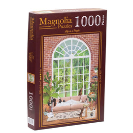 Magnolia Puzzles Cat Sanctuary jigsaw puzzle featuring a cozy indoor scene with windows and a sofa, showcasing various cats and decorative plants. The puzzle consists of 1000 pieces and promotes a relaxing activity to enjoy alone or with family and friends.