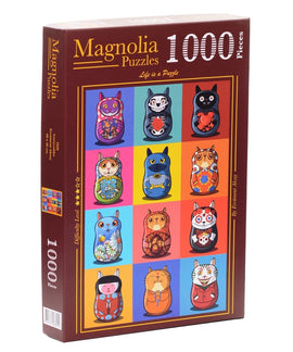 A colorful jigsaw puzzle box containing 1000 pieces from Magnolia Puzzles, featuring a vibrant assortment of cat-themed nesting dolls, illustrated in various playful designs and colors, set against a multicolored grid background.