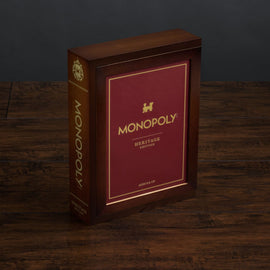Monopoly Heritage Edition board game by Winning Solutions, featuring a luxurious maroon box with gold lettering and decorative details. Ideal for game nights with family and friends, designed for players ages 8 and up.