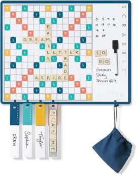 Scrabble 2-in-1 Message Board by Winning Solutions featuring a dual-use design. The game board displays words like 'FAMILY' and 'DREAM' with points, while also serving as a message board on the right. Includes letter tiles and a small fabric bag for storage, and clear markers for players' names.