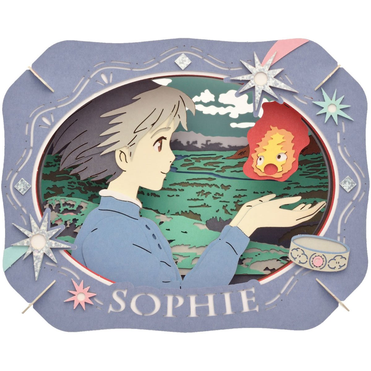 A detailed Paper Theater DIY kit featuring Sophie from Howl's Moving Castle. The layered design showcases Sophie holding a small flame creature, surrounded by a scenic backdrop of hills and greenery. The kit includes decorative elements like stars and a bowl, all crafted from colored paper, creating a whimsical three-dimensional effect.