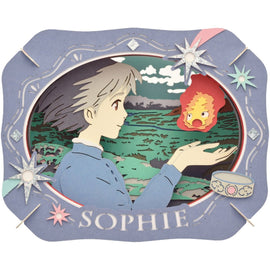 A detailed Paper Theater DIY kit featuring Sophie from Howl's Moving Castle. The layered design showcases Sophie holding a small flame creature, surrounded by a scenic backdrop of hills and greenery. The kit includes decorative elements like stars and a bowl, all crafted from colored paper, creating a whimsical three-dimensional effect.