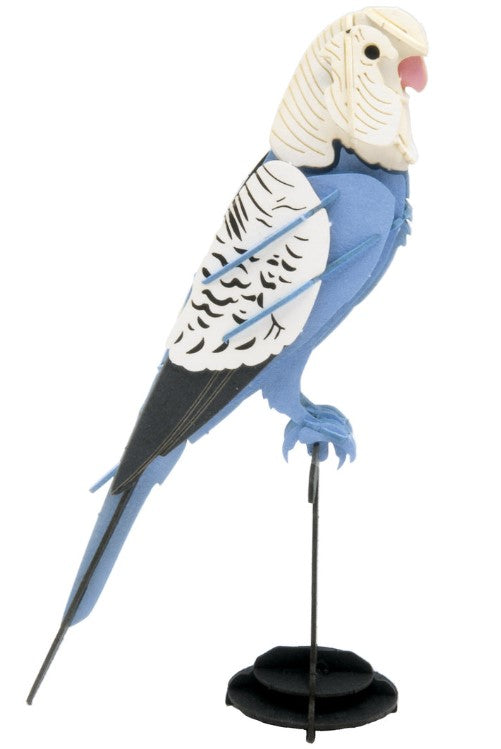 A detailed 3D paper model of a budgie, designed in vibrant blue and white colors. The model features intricate detailing on the feathers and a lifelike pose, showcasing the bird perched on a small black stand, perfect for display. Ideal for DIY enthusiasts and bird lovers.