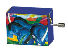 Franz Marc Blue Horses Music B by fridolin, a colorful music box showcasing an artwork of two blue horses against a vibrant background. The box features a winding mechanism on the side for music playback.