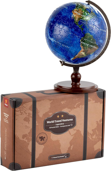 A 6-inch 3D puzzle globe by Pintoo displayed on a wooden base. The globe is composed of colorful jigsaw pieces showing continents and oceans. The product box features a vintage map design and highlights that it includes a transparent globe with a C-stand for display.